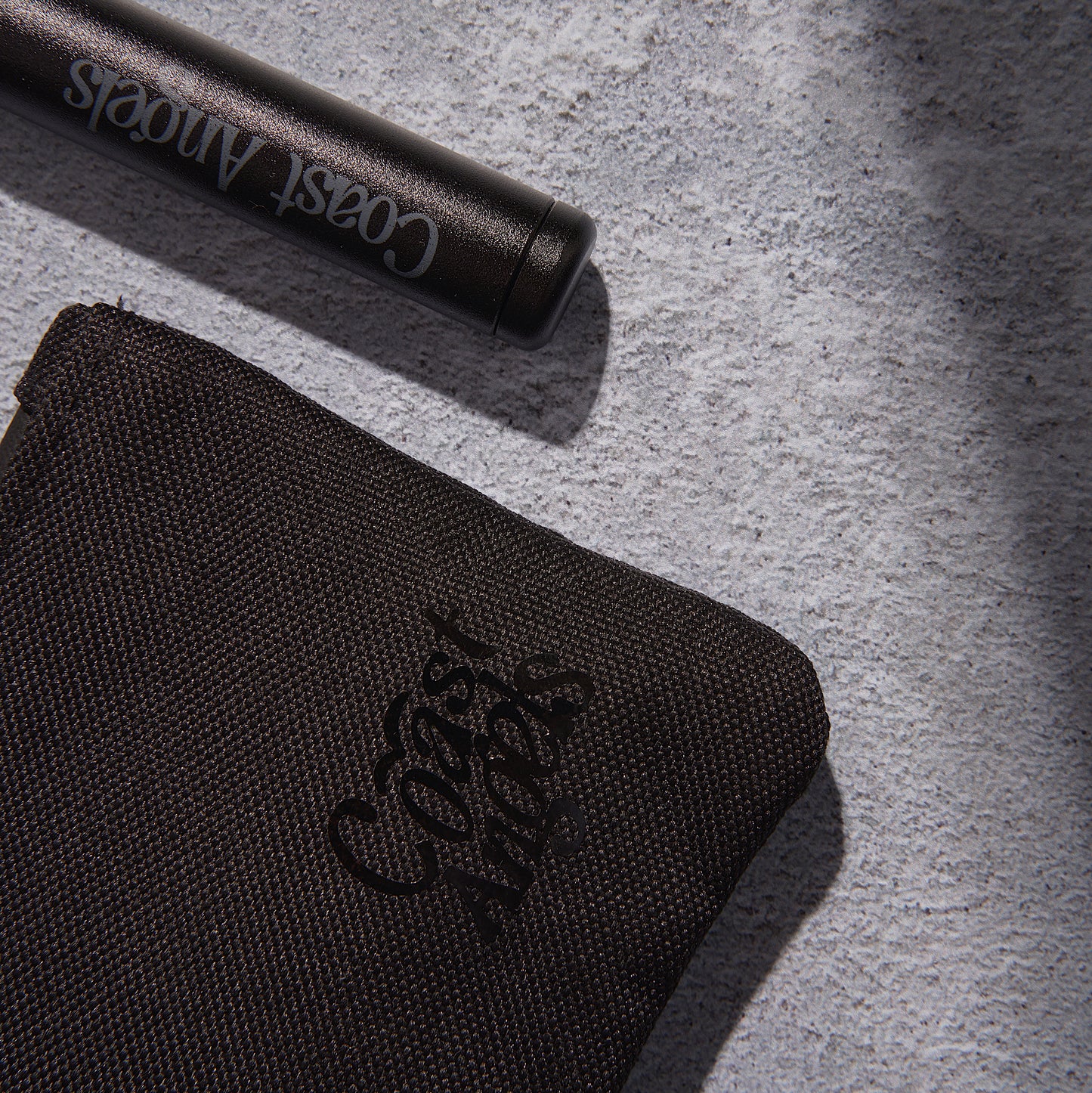 Close-up of Coast Angels Camden Smell Proof Pouch and Doob Tube, showcasing detailed craftsmanship and Coast Angels logo.