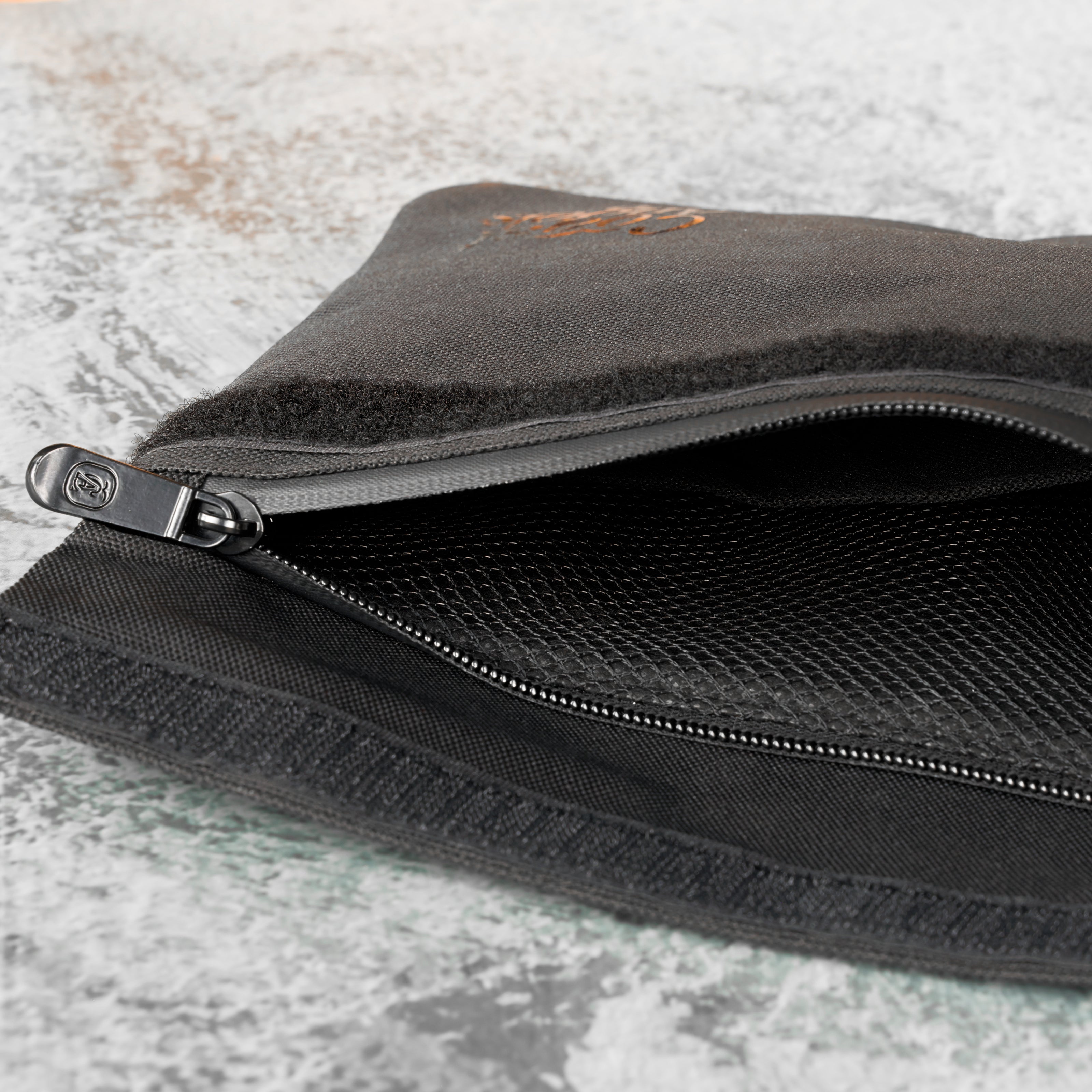 Close-up of the open Coast Angels Soho pouch showing the internal mesh compartment and zipper, highlighting the bag’s organised interior and secure storage features.